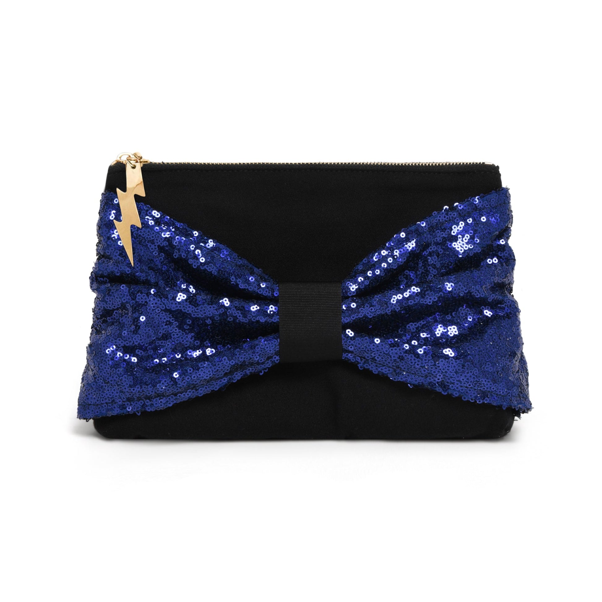 A navy clutch bag featuring a large, voluminous bow made of royal blue sequins, with a small gold lightning-bolt charm on the zipper pull, set against a plain white background.