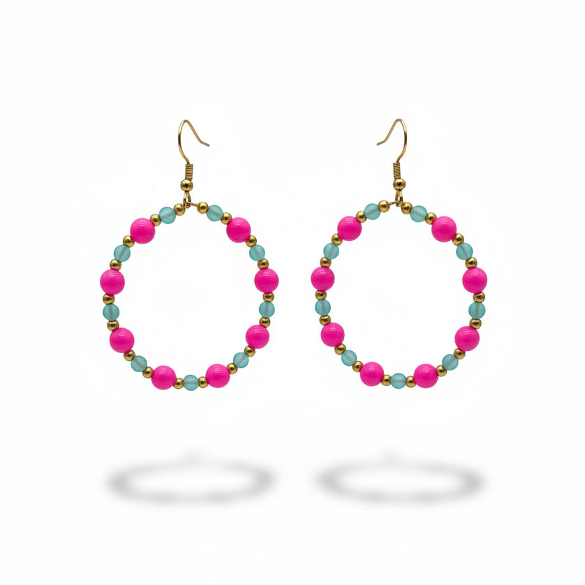A pair of handmade hoop earrings with bright pink and turquoise beads against a neutral gray background.